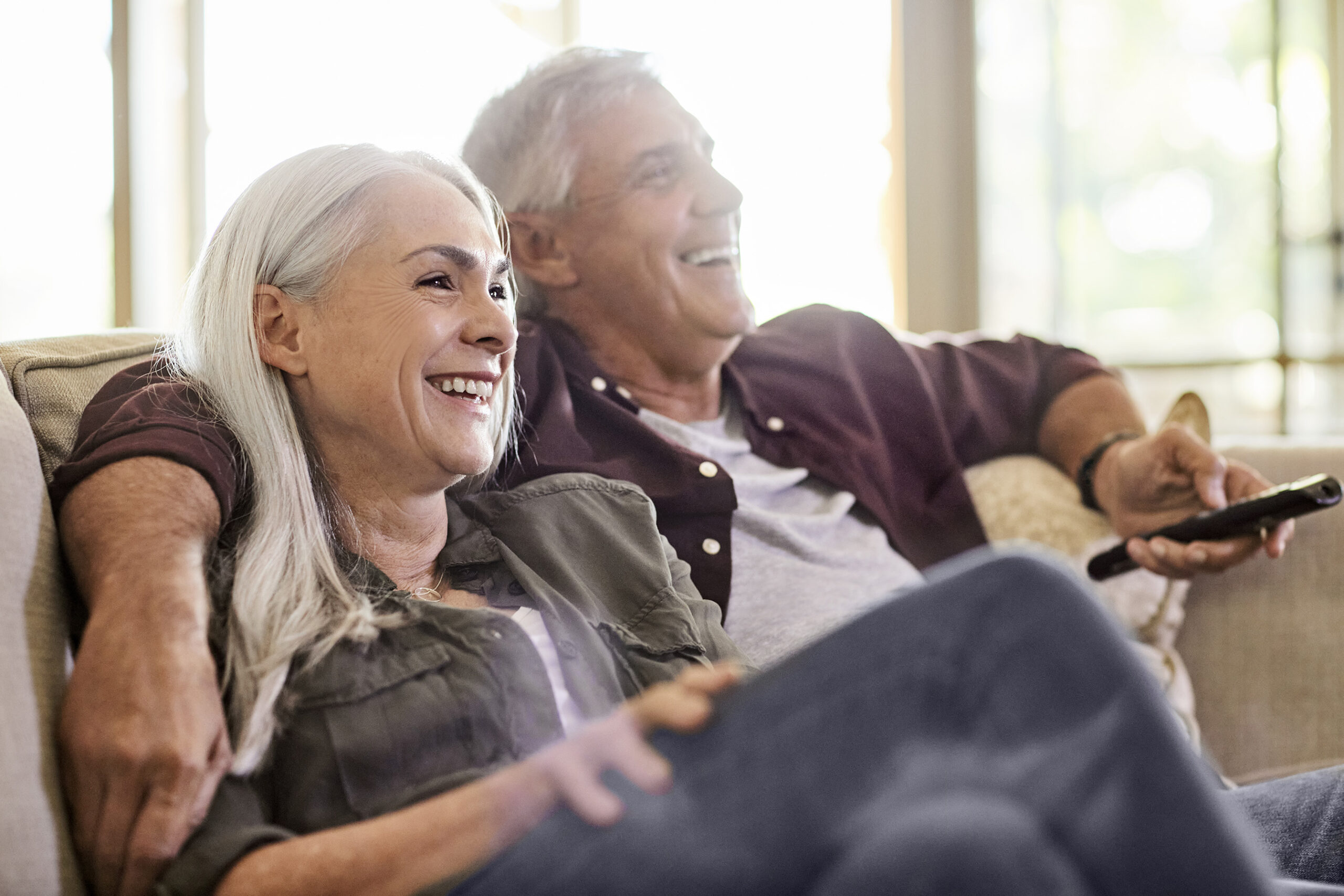 Two people sitting on a couch at Patrick's Pointe new apartments in Southern Pines, NC